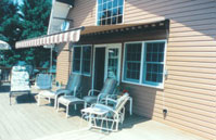 tan and white striped awning perched over a deck
