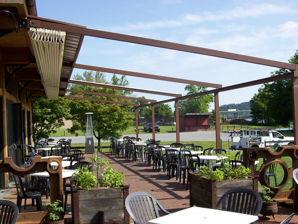 restaurant with a newly installed pergola that is open all the way since it is nice weather