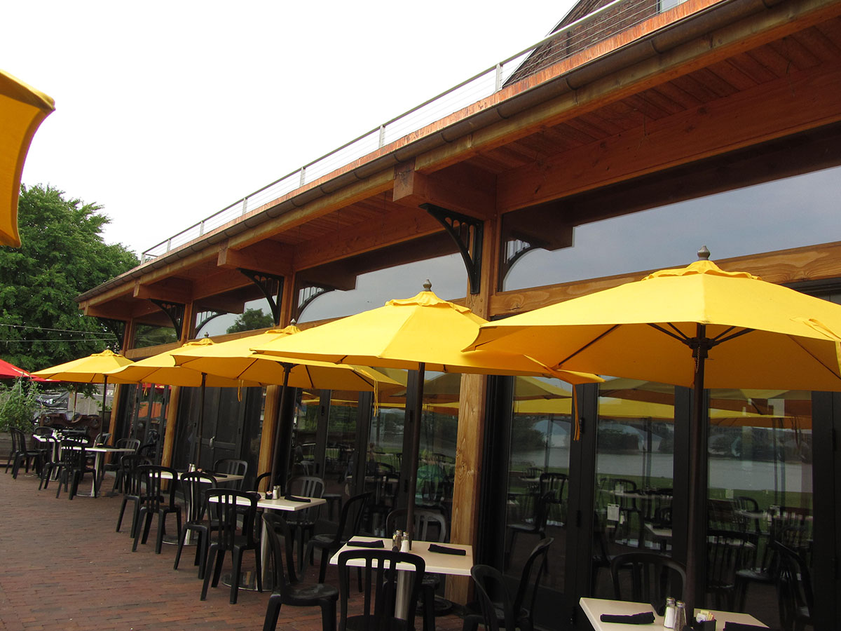 yellow umbrellas opened up over tables and lined up