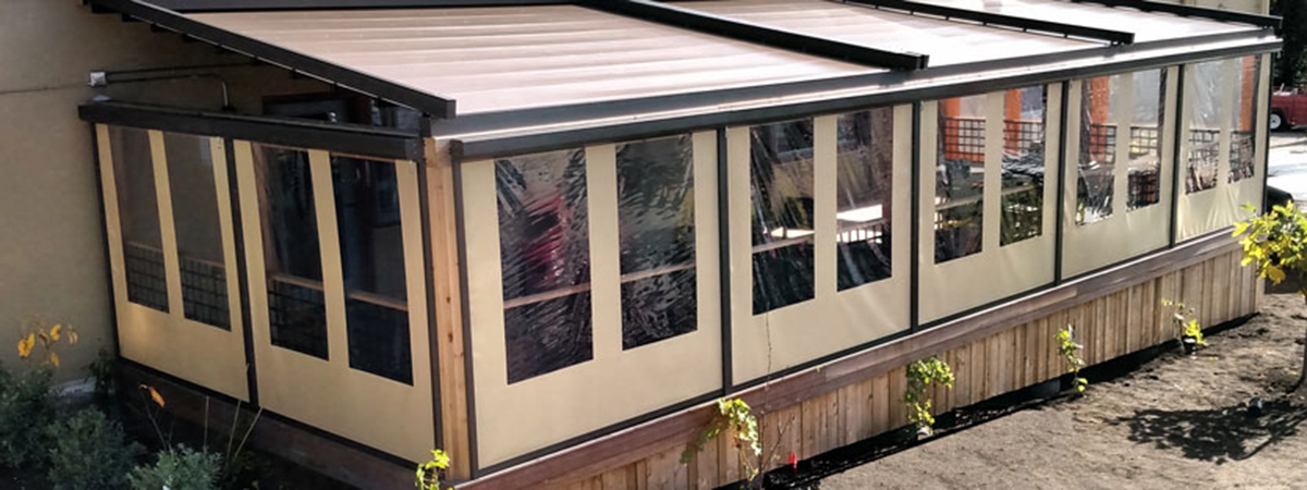 up high view of a pergola with the roof closed and side roller windows all the way down