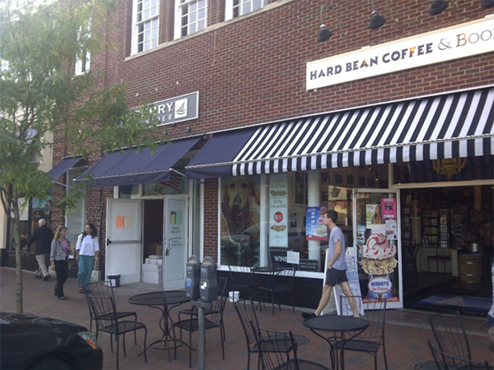 Hard Bean Coffee storefront with striped awning over the entrance and window