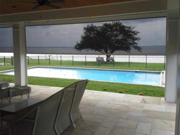 front porch with screens open overlooking a pool