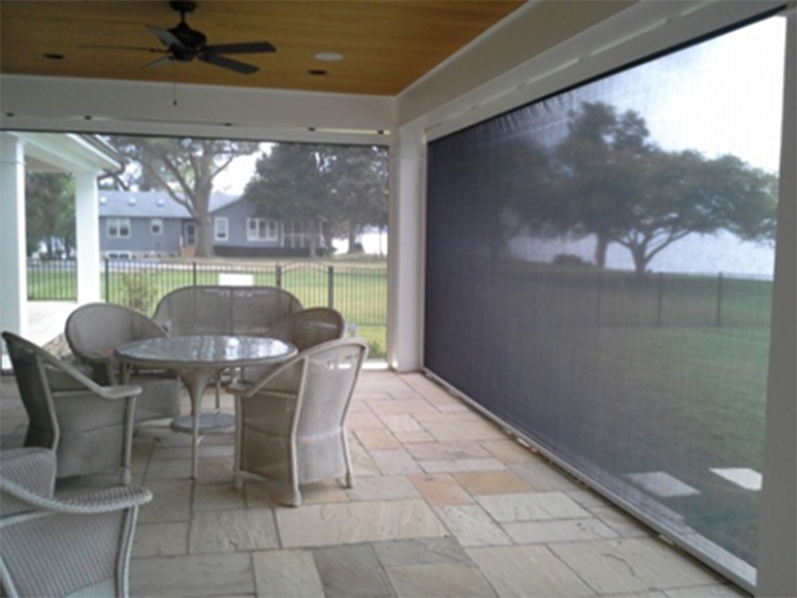 front porch with screens closed and lounge furniture on tile floor