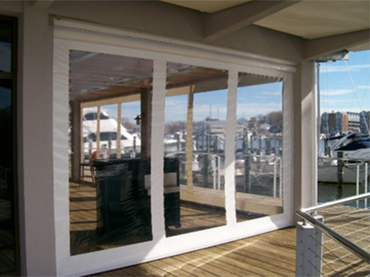 deck patio for a restaurant on a dock with zipper screens closed