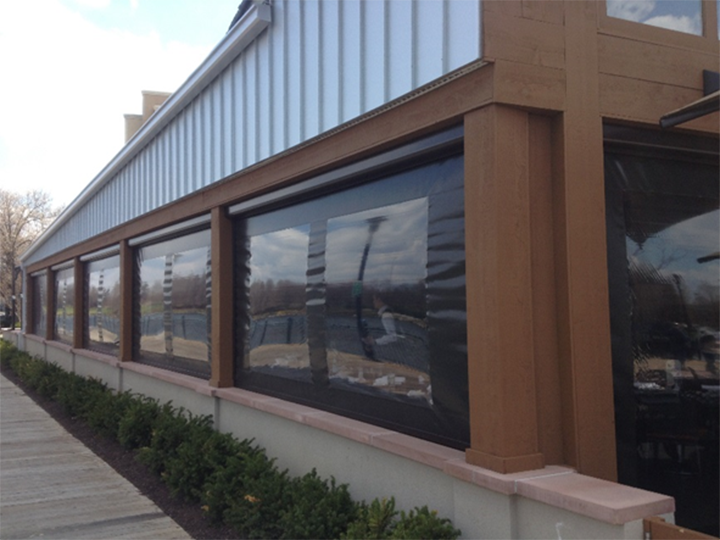 brown building with black screen zipper shades