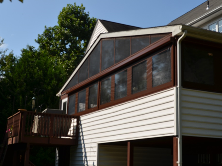 white residential house with brown screen shades